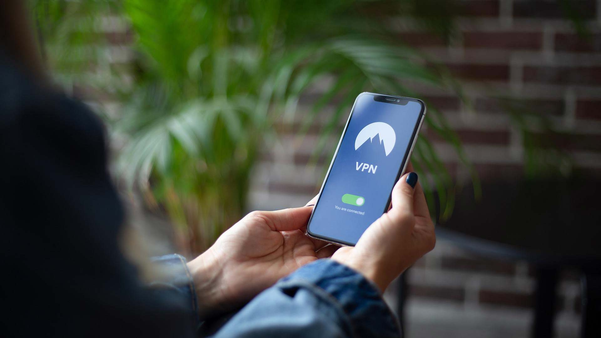 Person using a VPN on laptop and smartphone